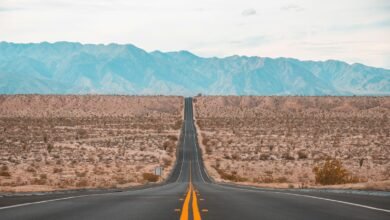 long exposure photography of black concrete road on open area during daytime